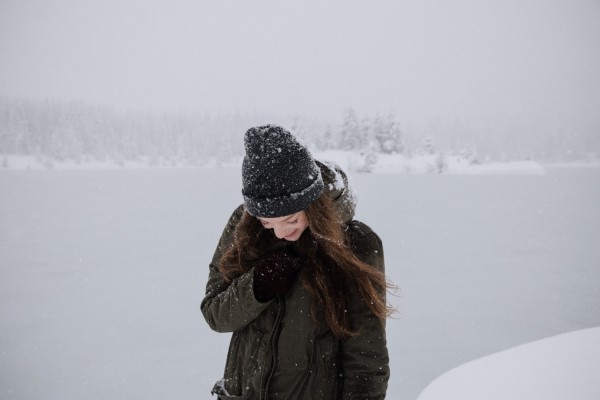 Woman wearing a black coat during winter Woman wearing a black coat during winter