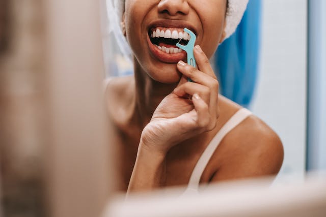 Girl flossing her white teeth
