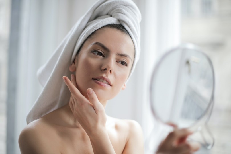 woman looking at herself in the mirror