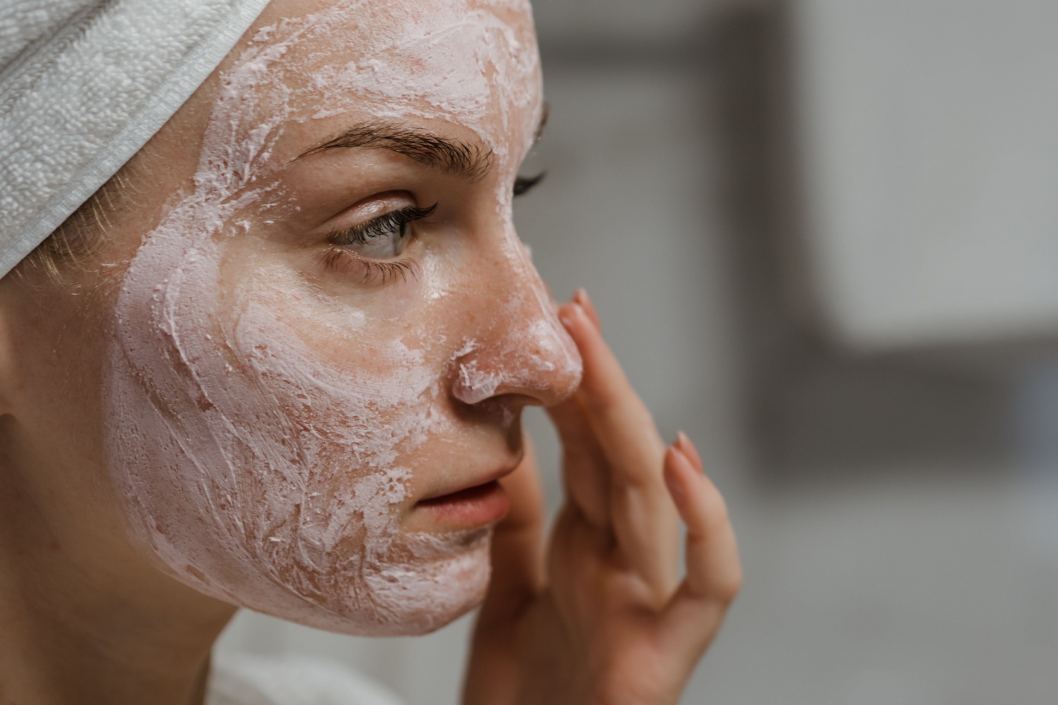 A woman using a skincare product 