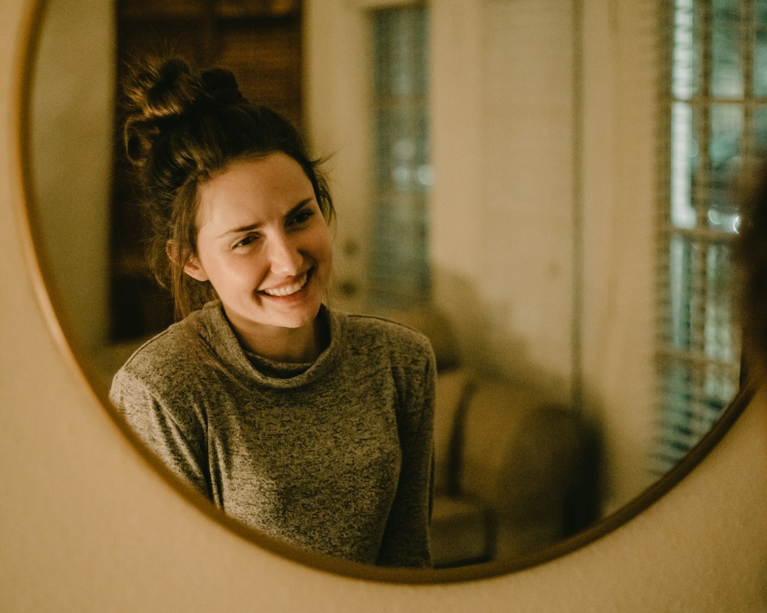smiling girl in front of mirror