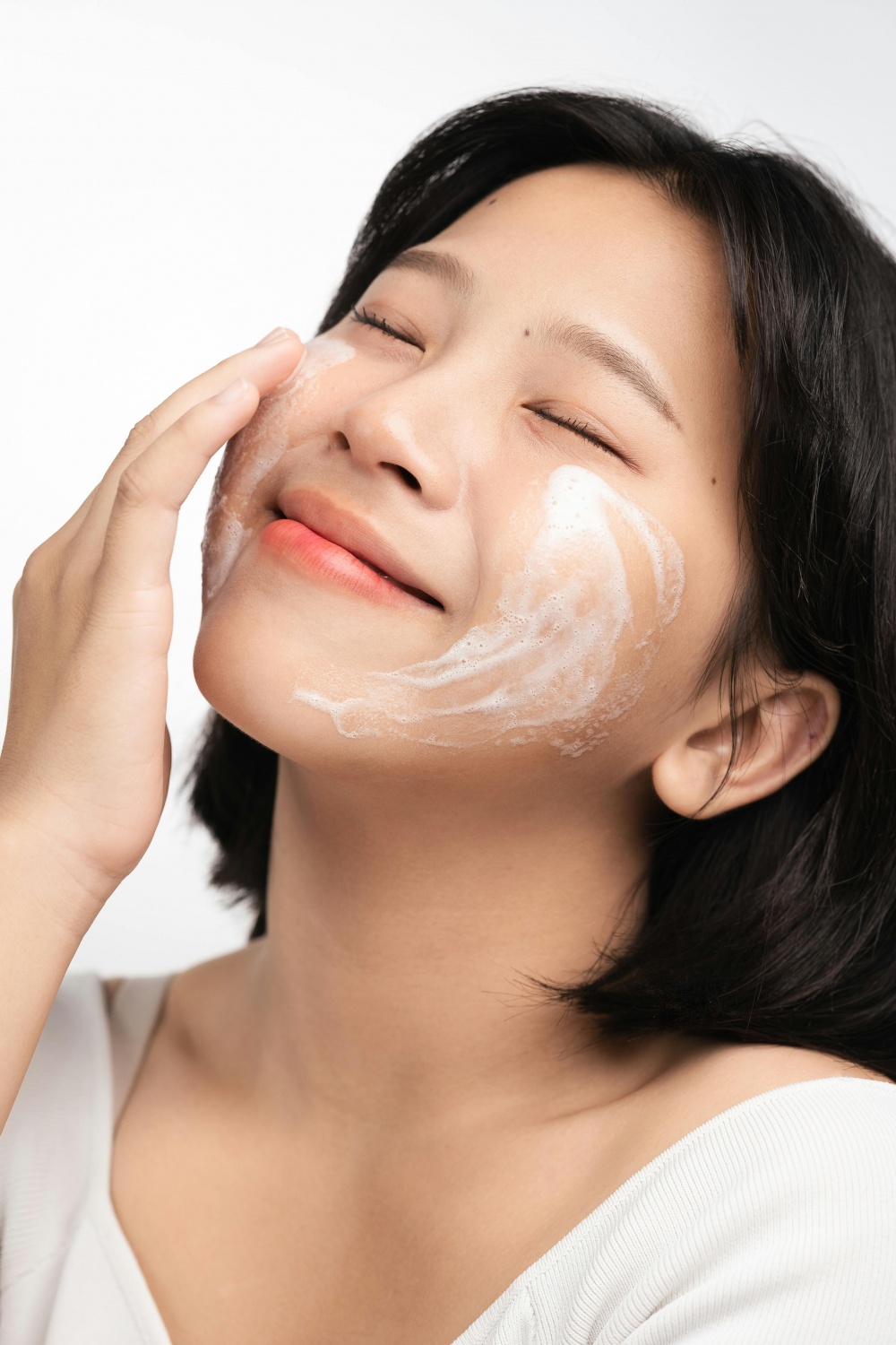 Asian woman washing face 