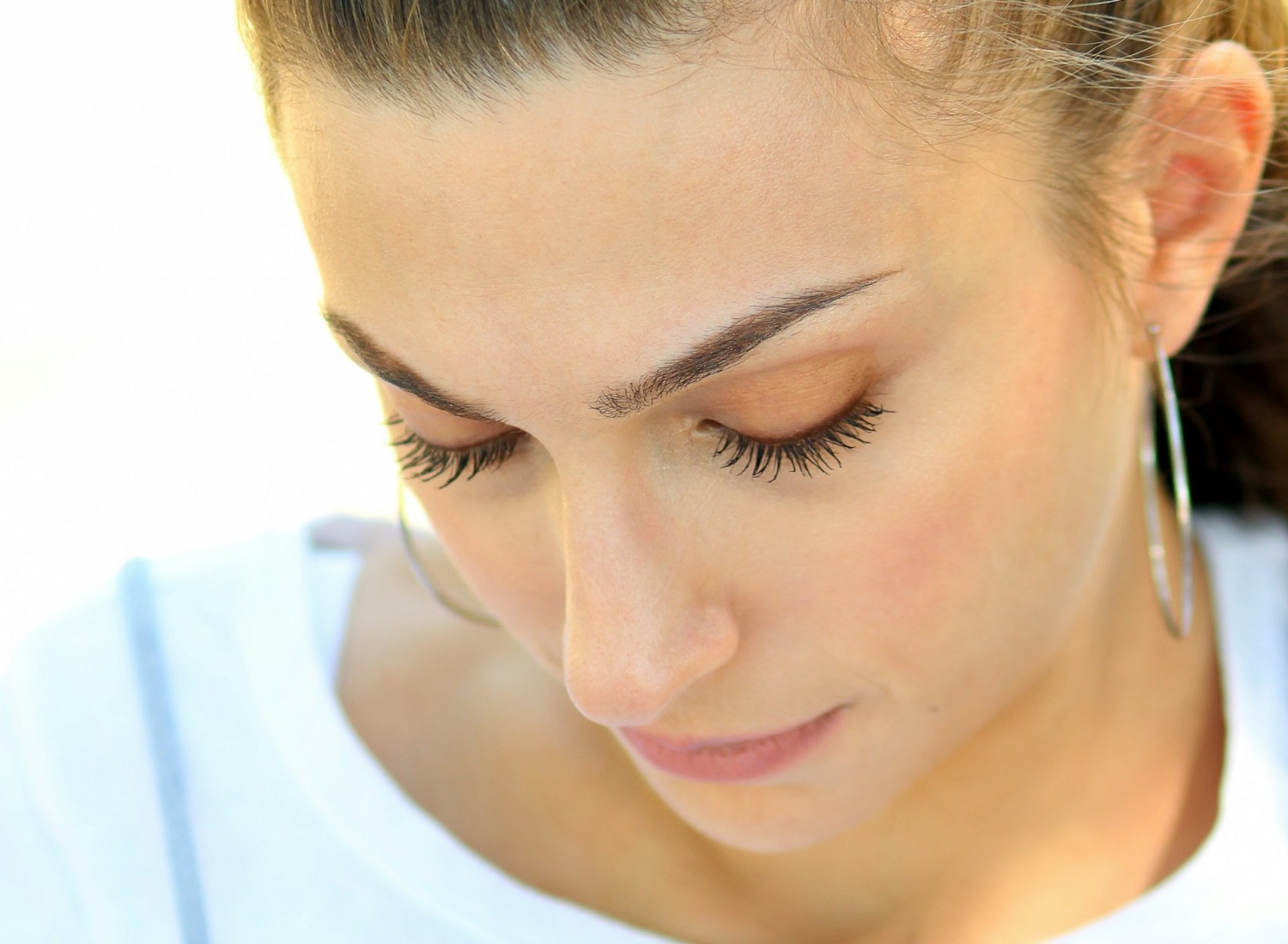 woman looking down with beautiful lashes