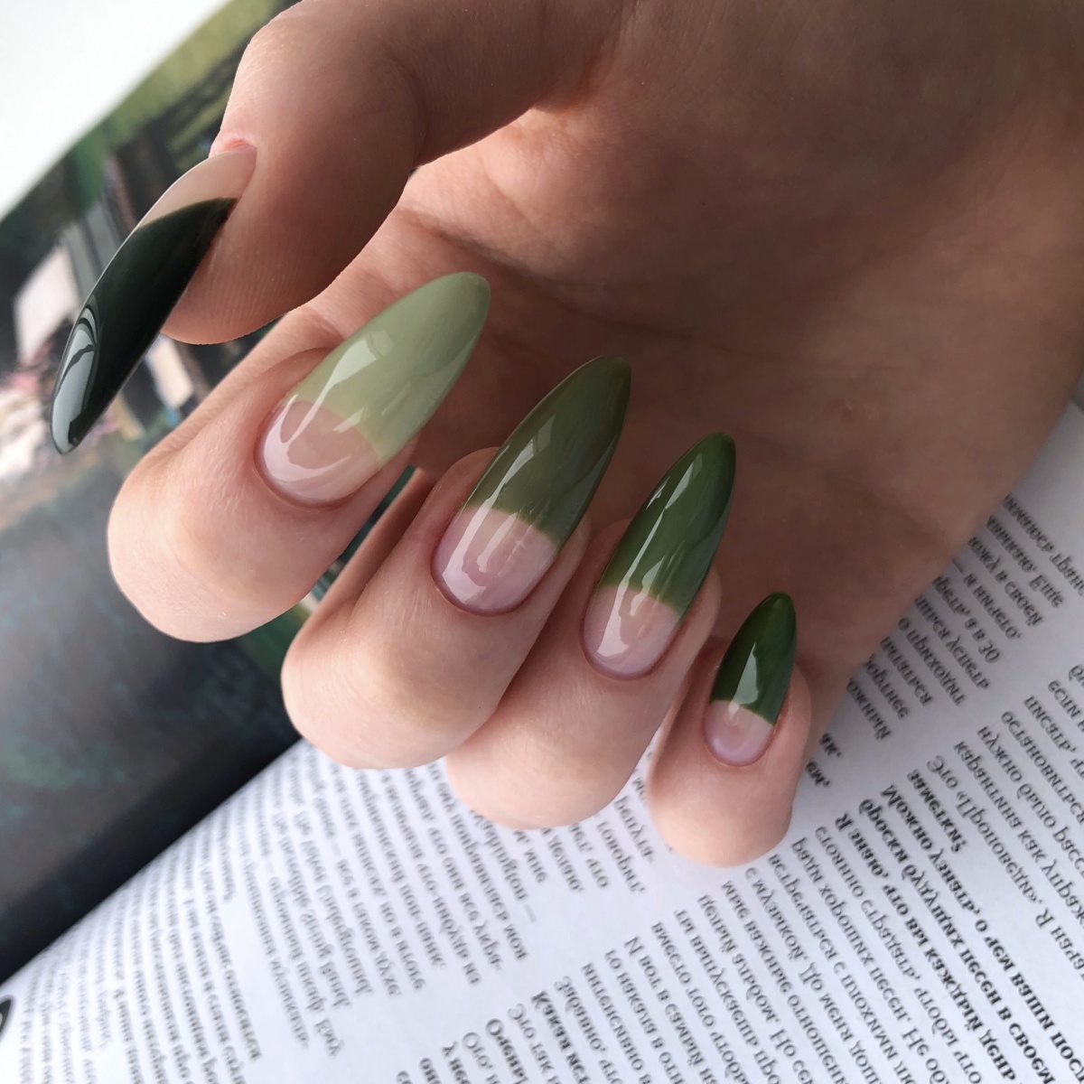 Woman with a green halfway manicure 