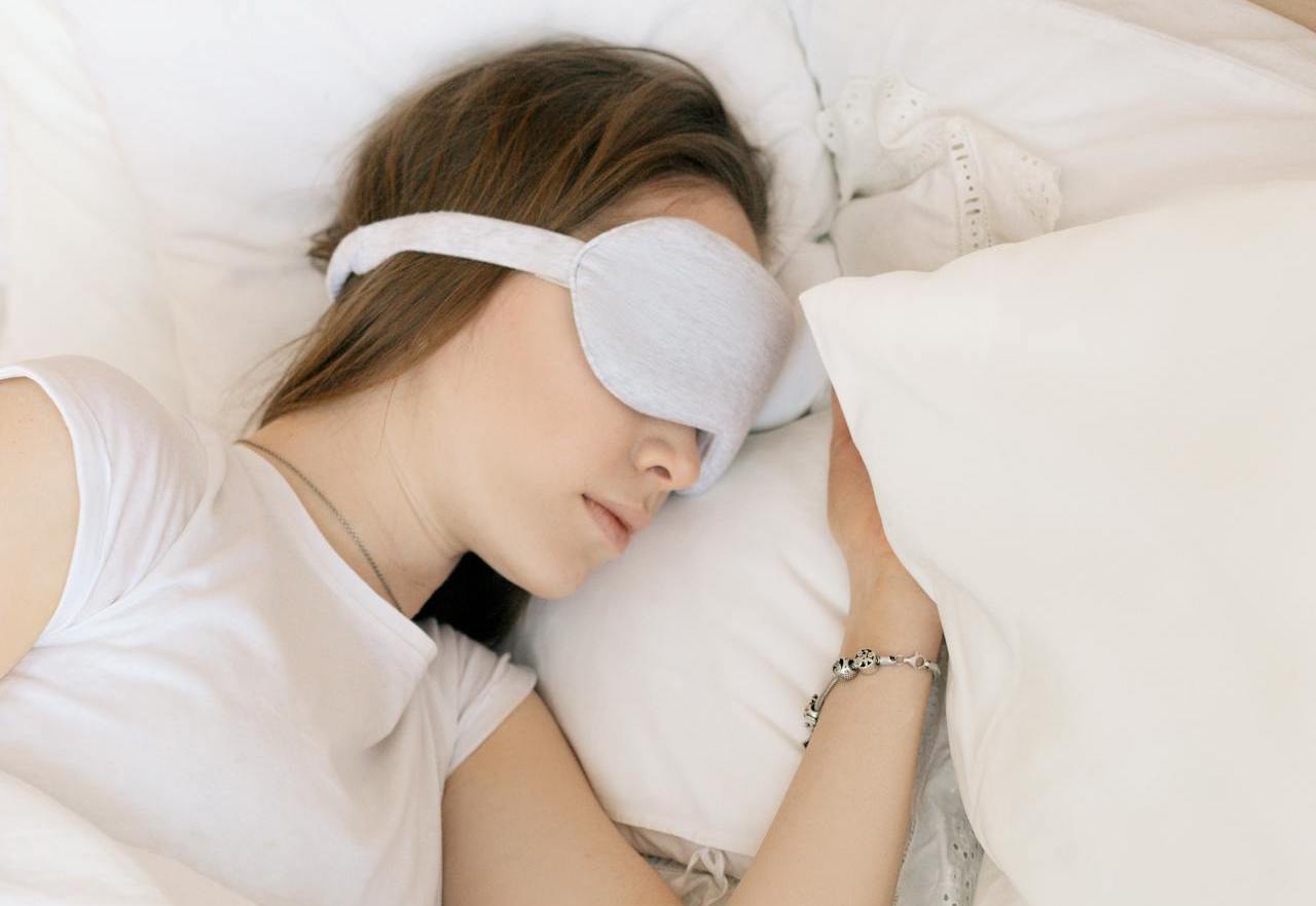 girl in white with sleep mask