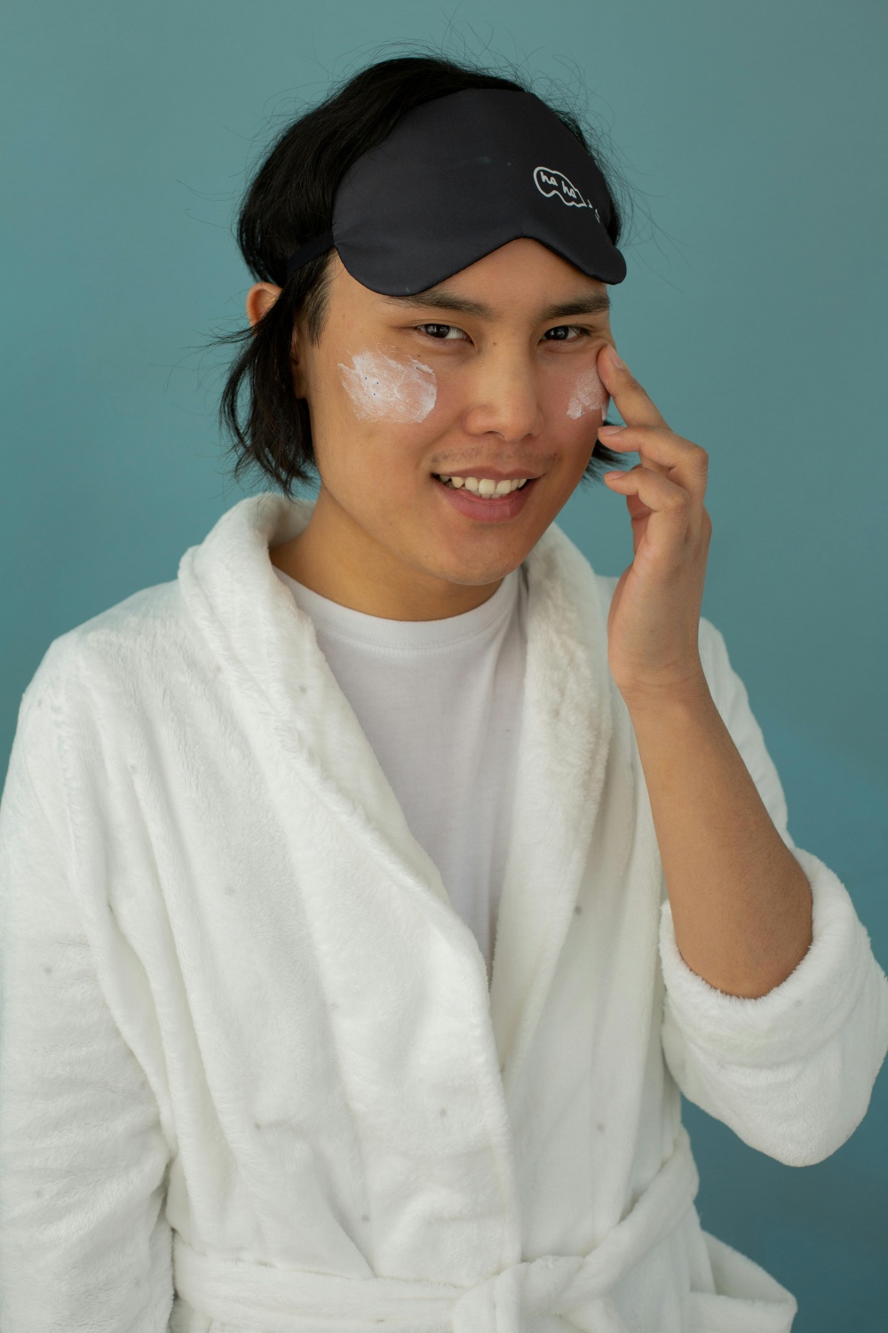 man with eye mask applying Moisturizers