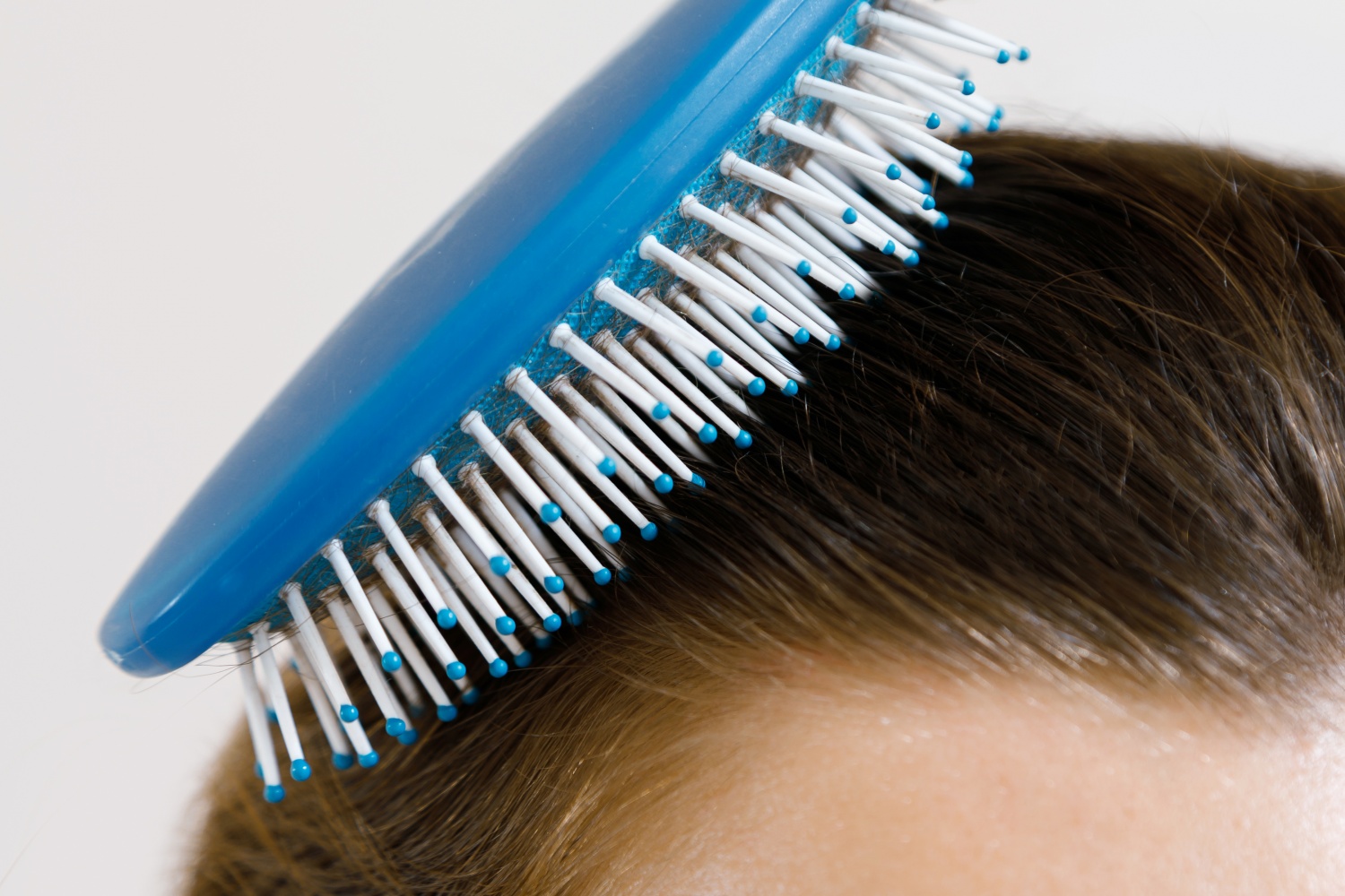 person using a hair brush 