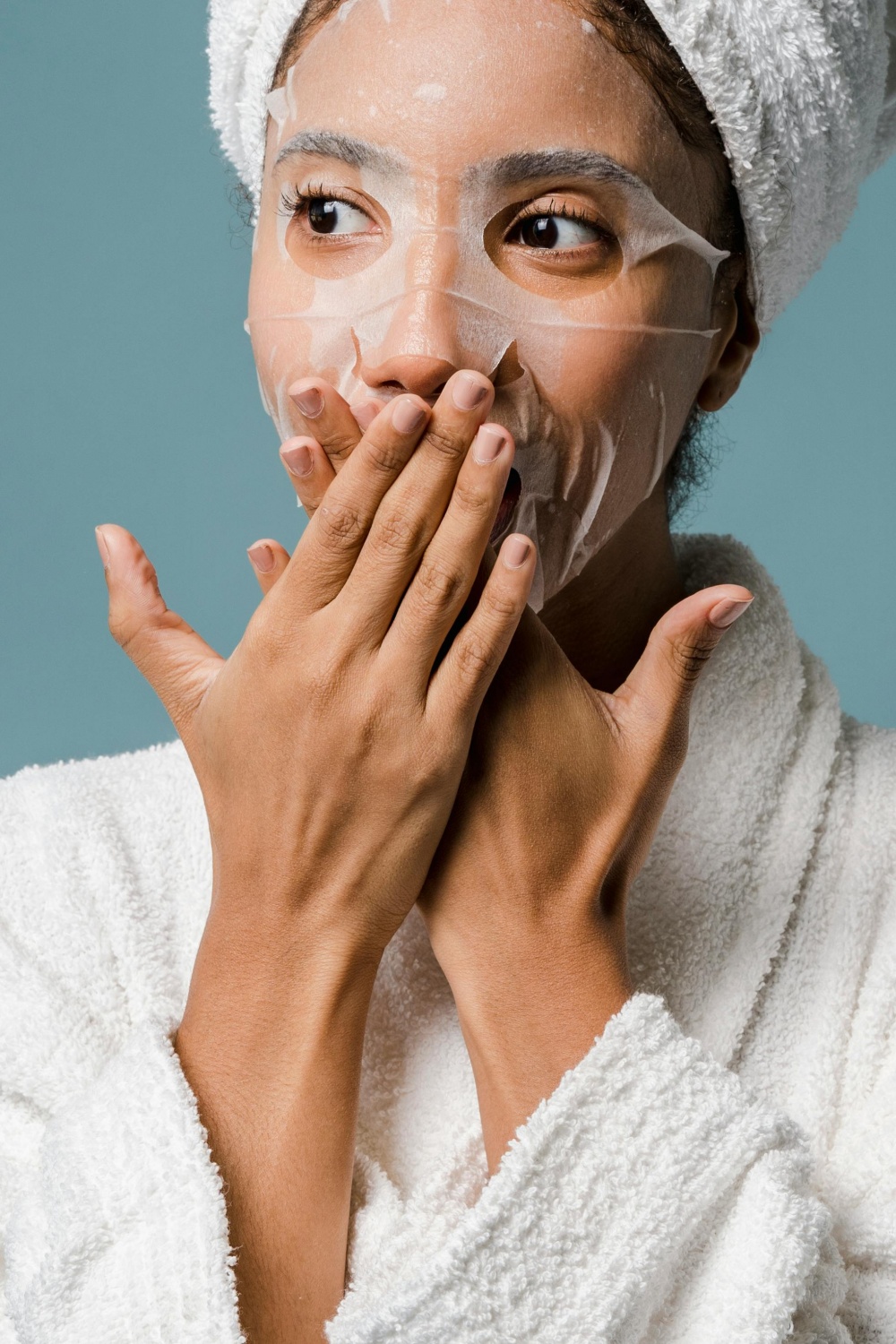  woman using a sheet mask 