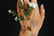 hand with band aid and flowers
