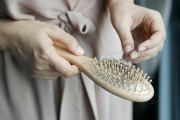 woman cleaning hair brush 