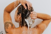 tan woman shampooing hair 