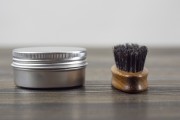 A jar of beard wax and brush 