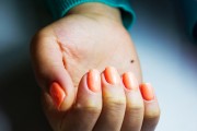 White woman with peach nails 