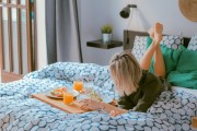 girl on bed with food and juice