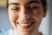 woman with face lotion on the nose