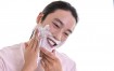 asian man applying shaving cream 